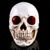 Statue crâne réaliste yeux rouges 19 cm